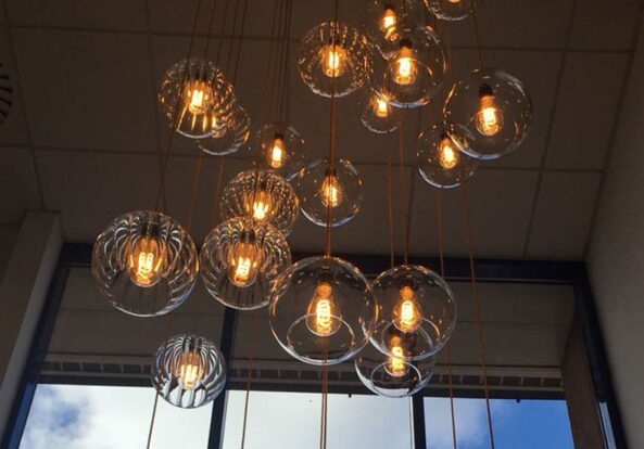 Stunning multi-pendant chandelier in office stairwell